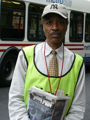 homeless newspaper vendor